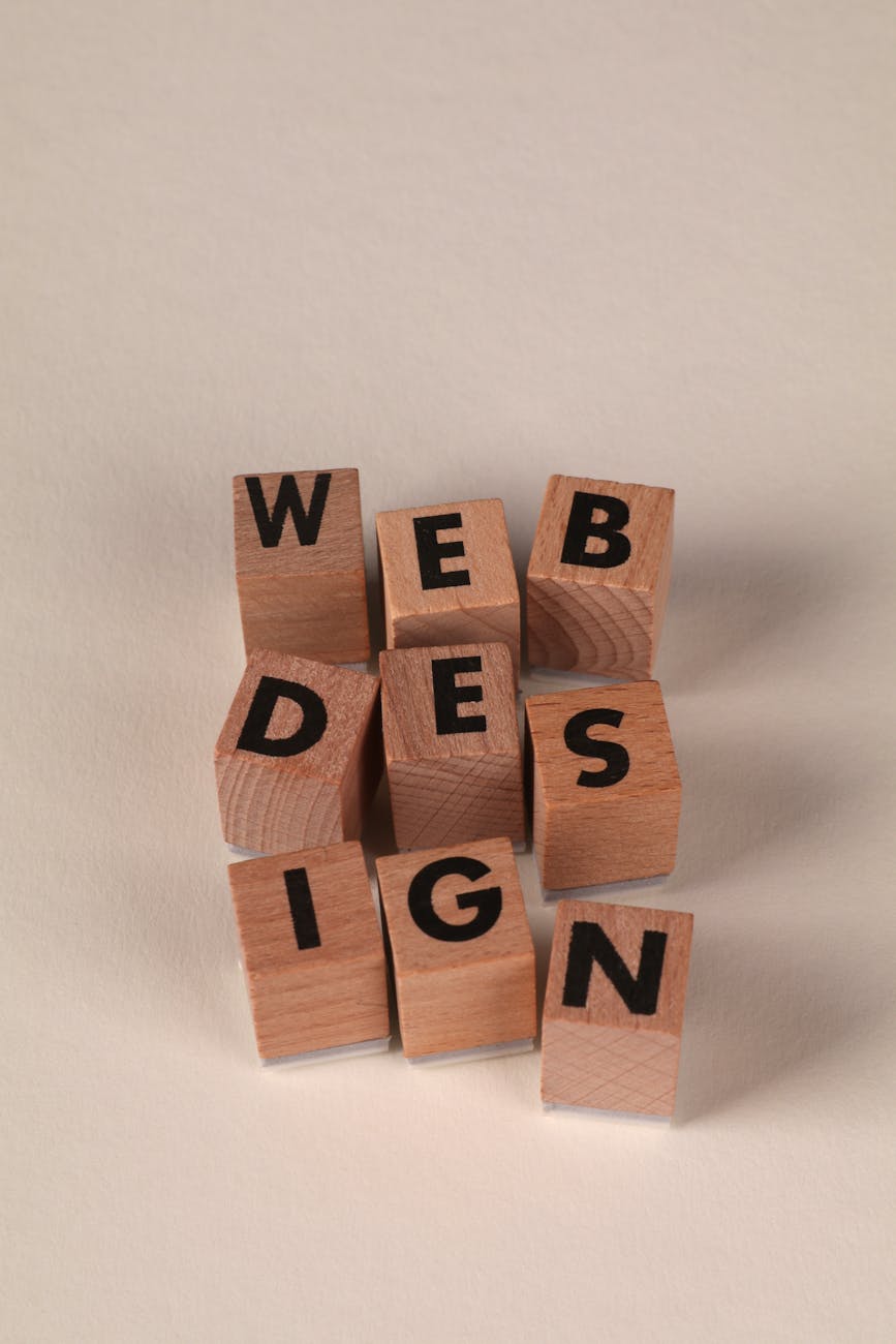 Wooden blocks arranged to spell 'Web Design'. Perfect for creative, digital content themes.