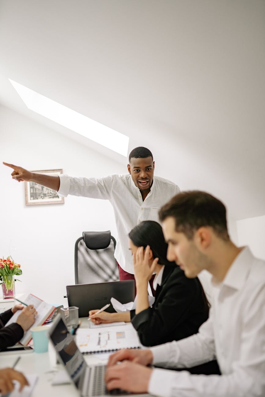 A dynamic team meeting in a modern office setting with engaged coworkers collaborating.