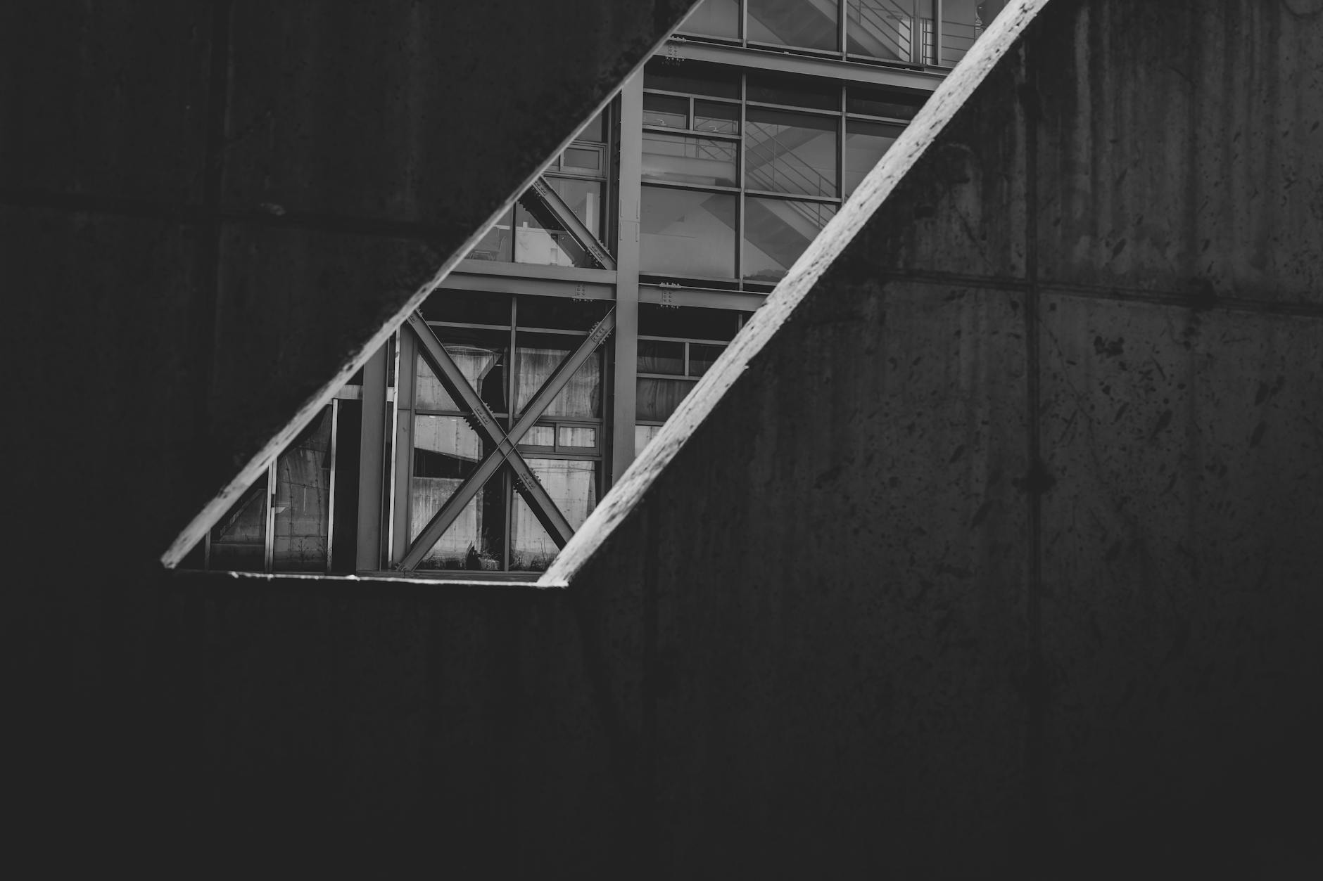 Black and white view of modern architecture through geometric opening.