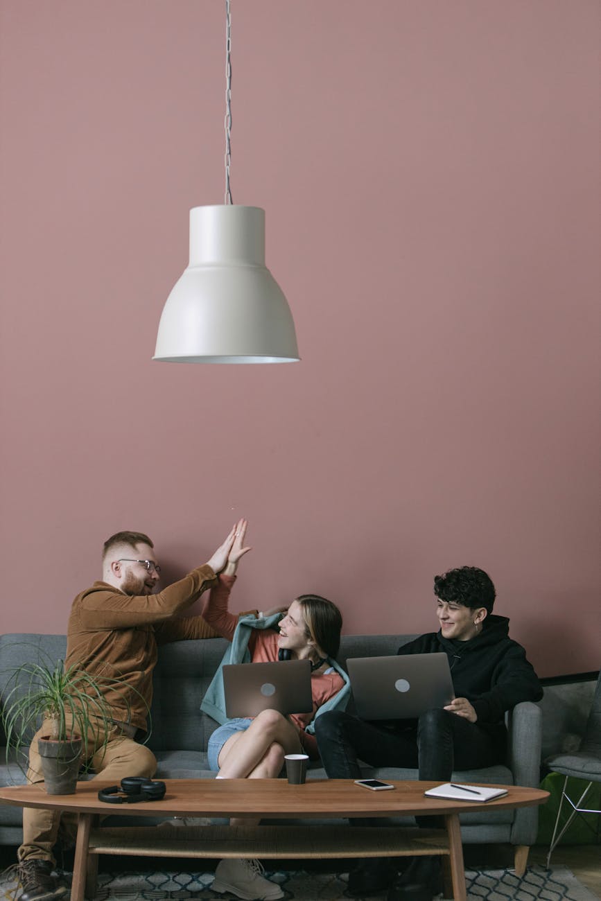 Three diverse team members collaborate in a stylish office setting.