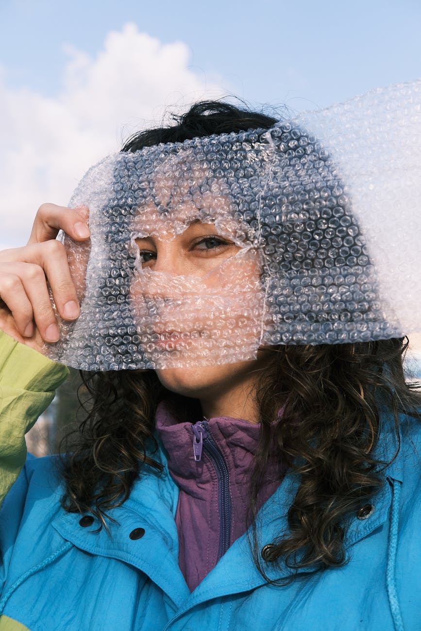 Artistic portrait featuring a woman holding bubble wrap, capturing modern art and creativity.