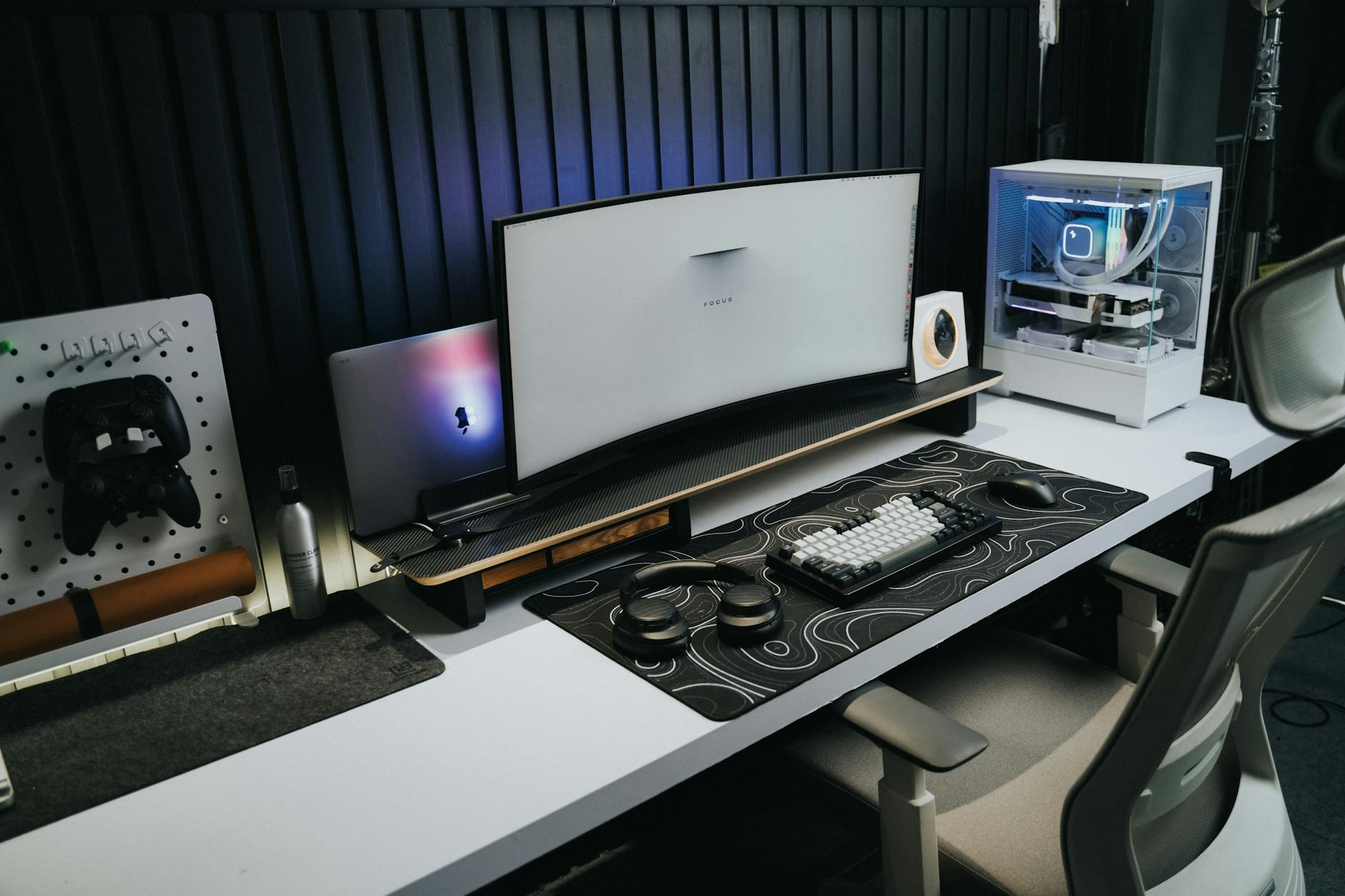 A sleek, modern office setup with a gaming PC, curved monitor, and accessories, ideal for tech enthusiasts.