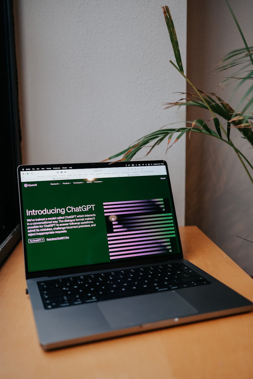A laptop on a desk showing a ChatGPT interface, symbolizing modern AI technology in daily use.