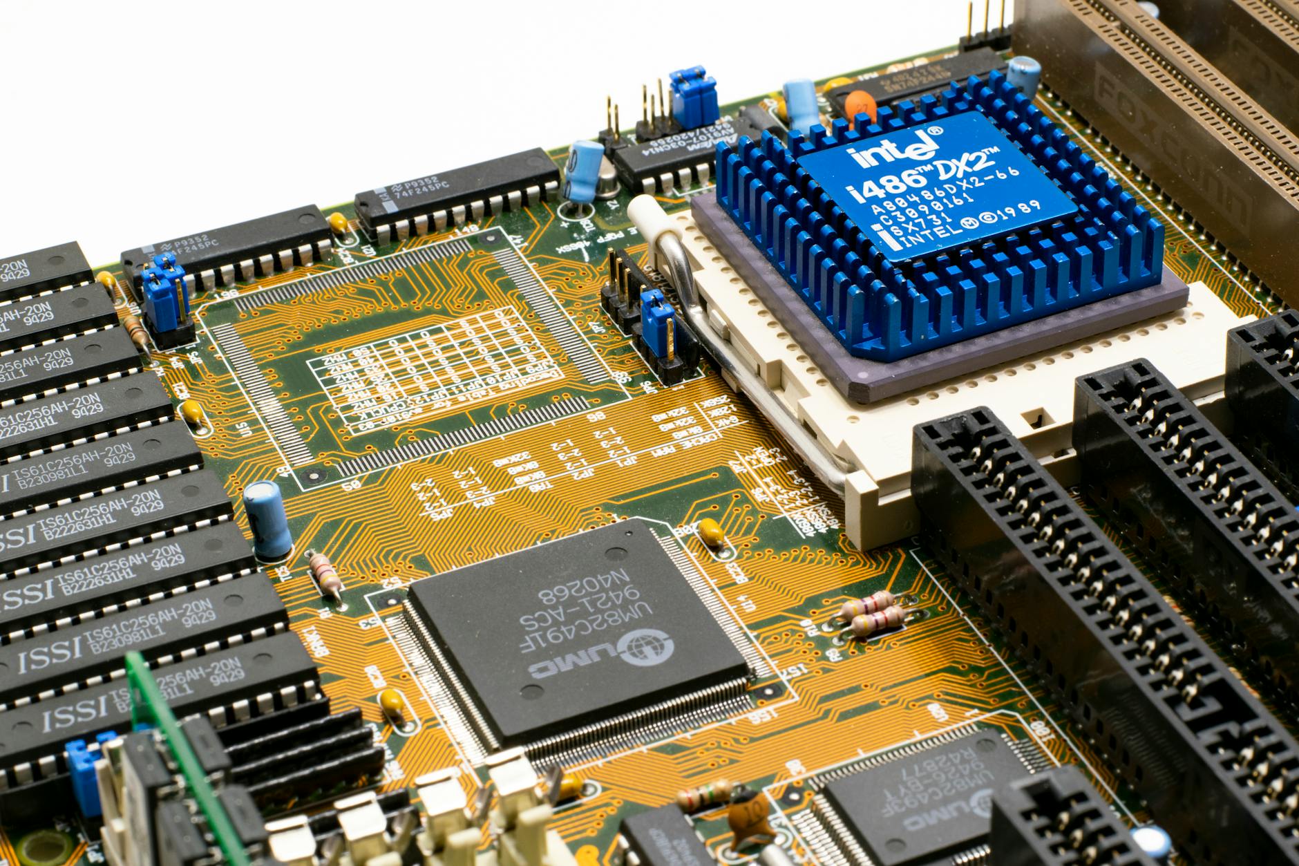 Detailed view of an Intel i486 DX2 CPU installed on a vintage motherboard with chips and circuits.