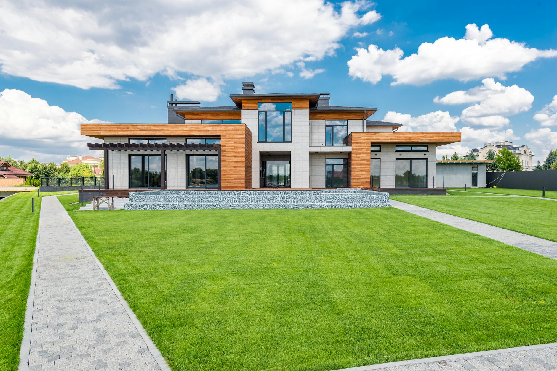 Stunning modern house exterior showcasing spacious lawn and contemporary architecture.