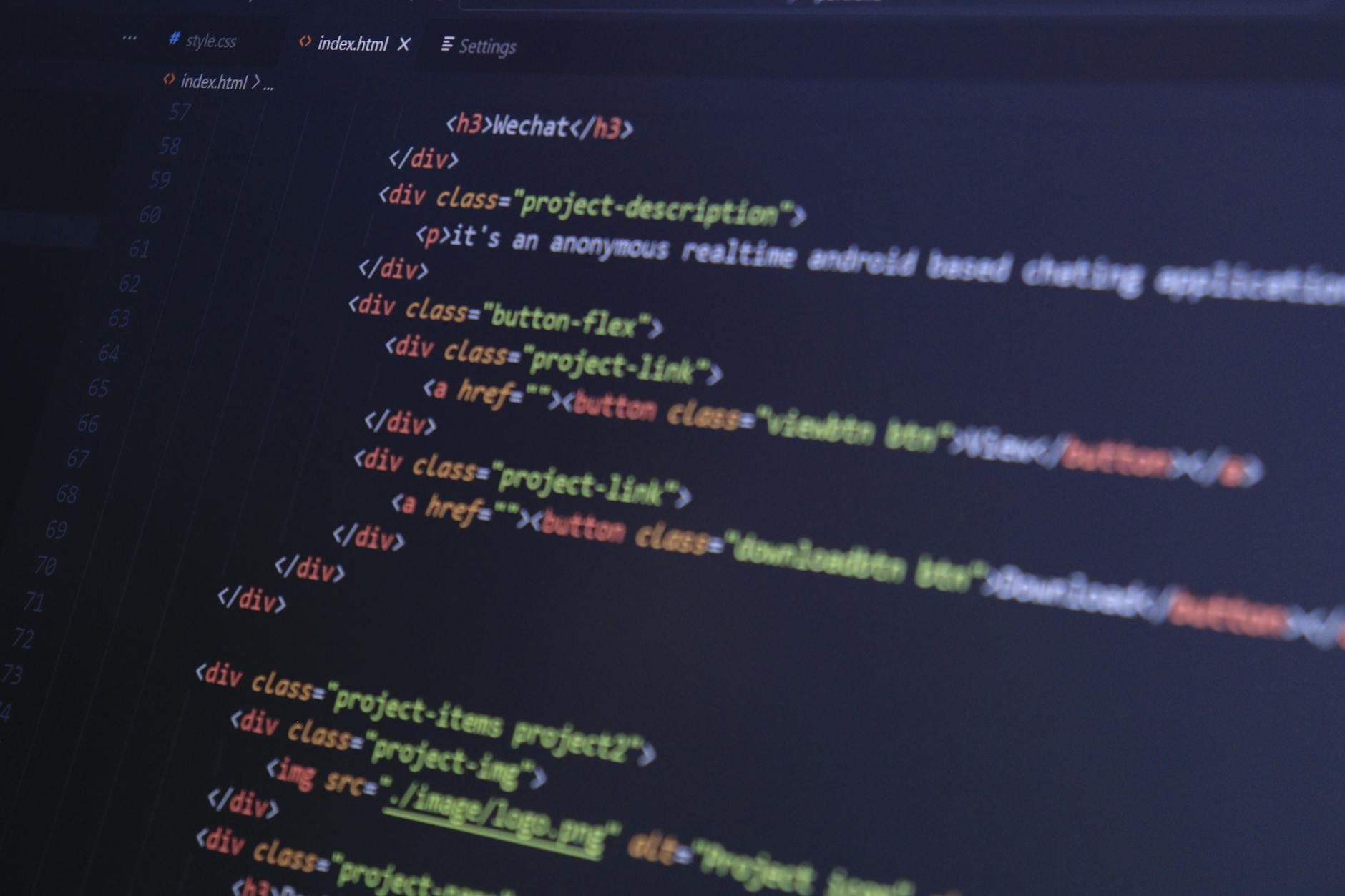 Close-up of HTML code with syntax highlighting on a computer monitor.