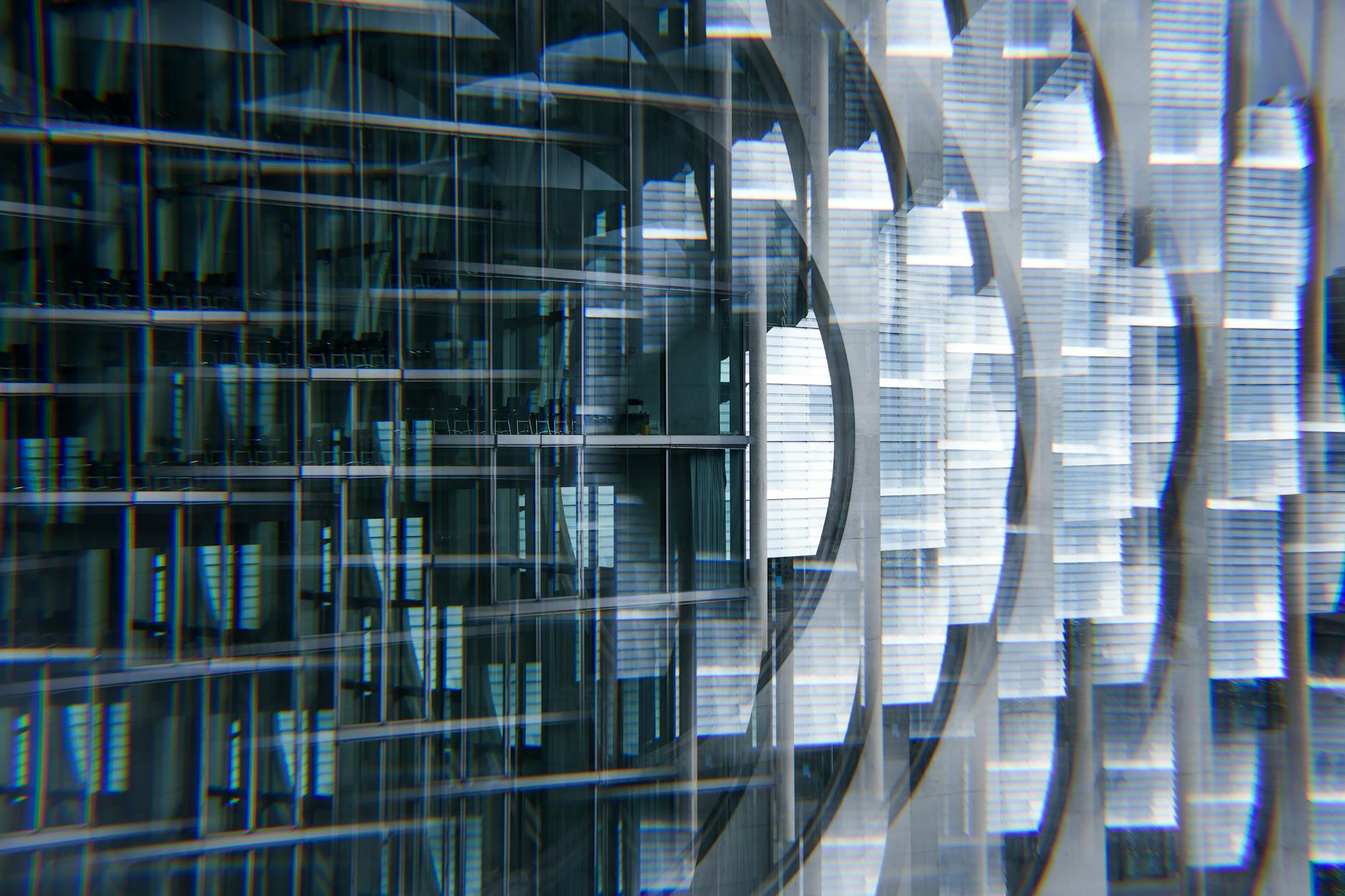 Abstract view of a modern skyscraper with glass reflections creating a futuristic urban look.