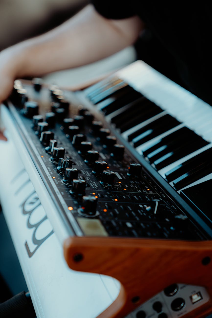 Detailed view of an analog synthesizer keyboard and control dials, perfect for music production.