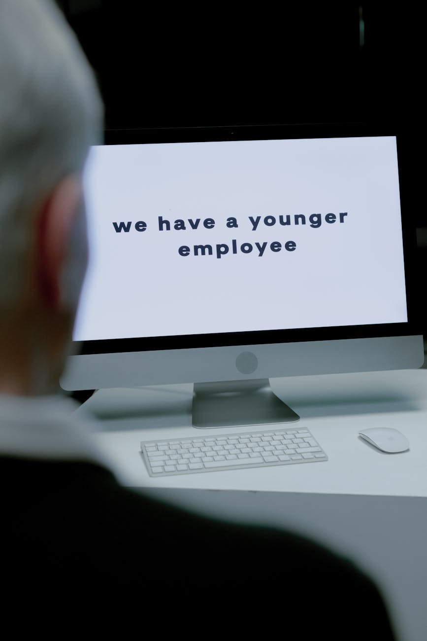 Senior adult facing age discrimination via computer message at workplace.