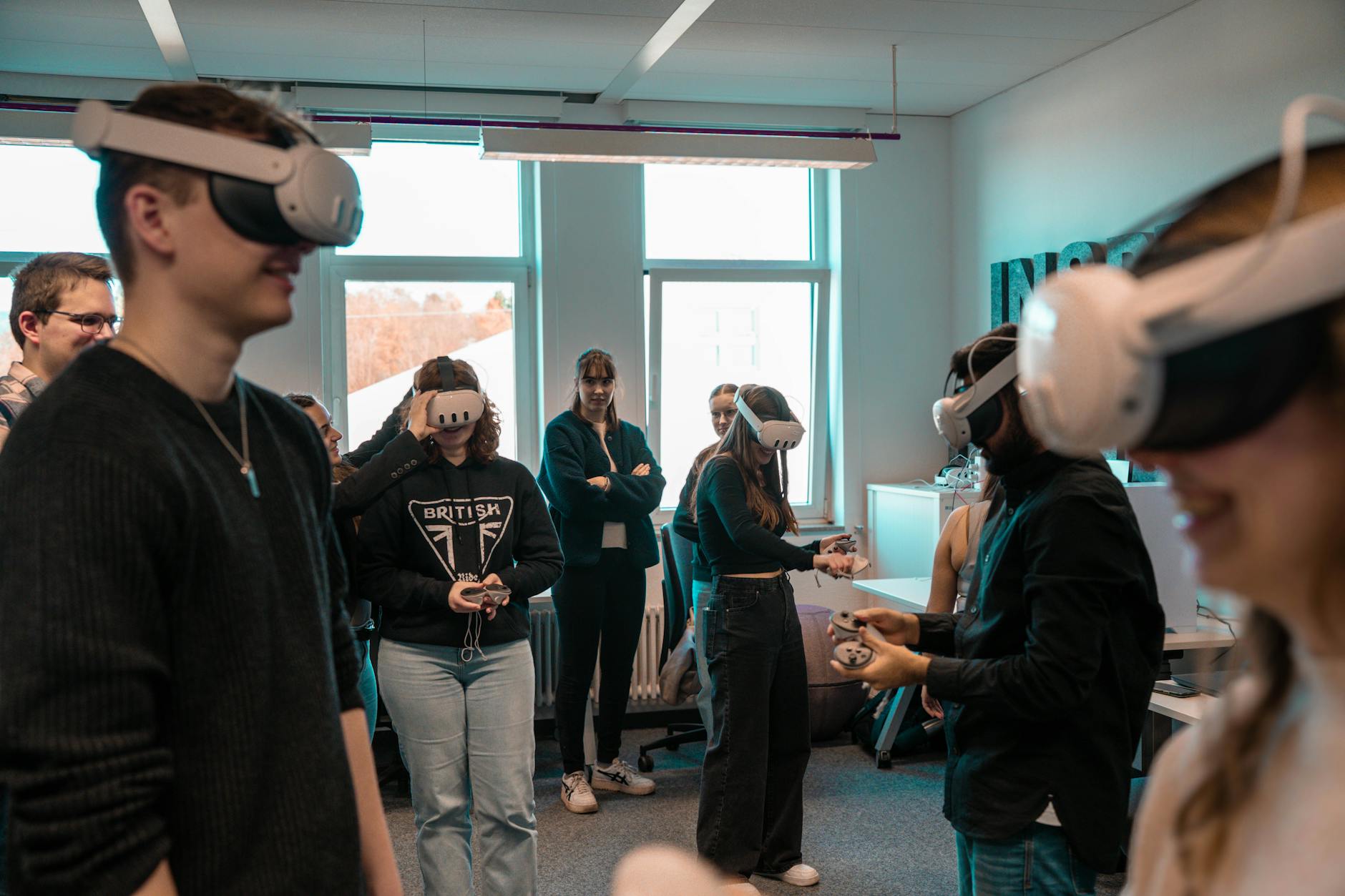 A group of diverse adults using VR headsets in an office setting.