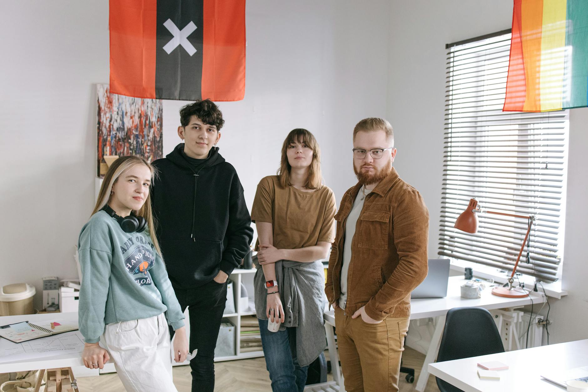 A group of young adults with diverse backgrounds gathered in a stylish office for collaboration.