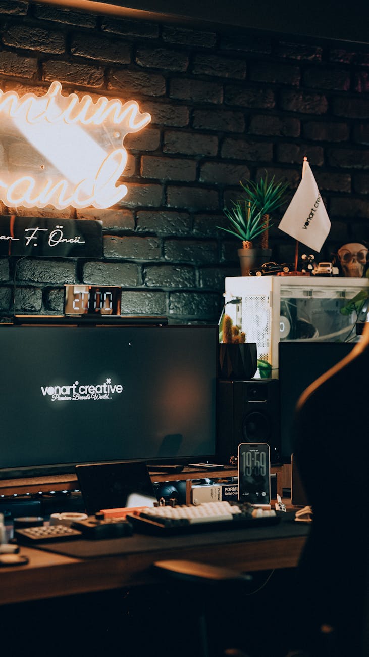 Stylish home office featuring neon lights, computer setup, and aesthetic decor. Ideal workspace inspiration.