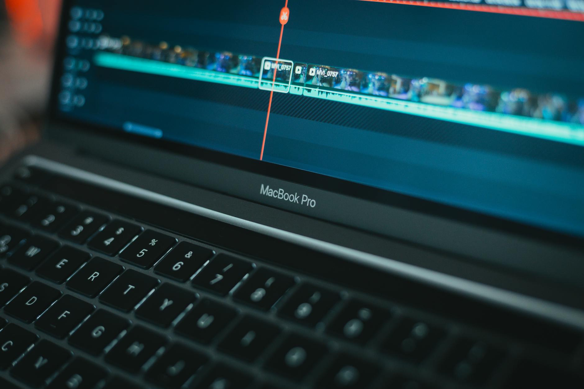 MacBook Pro with video editing software highlighting a timeline, showcasing technology in action.