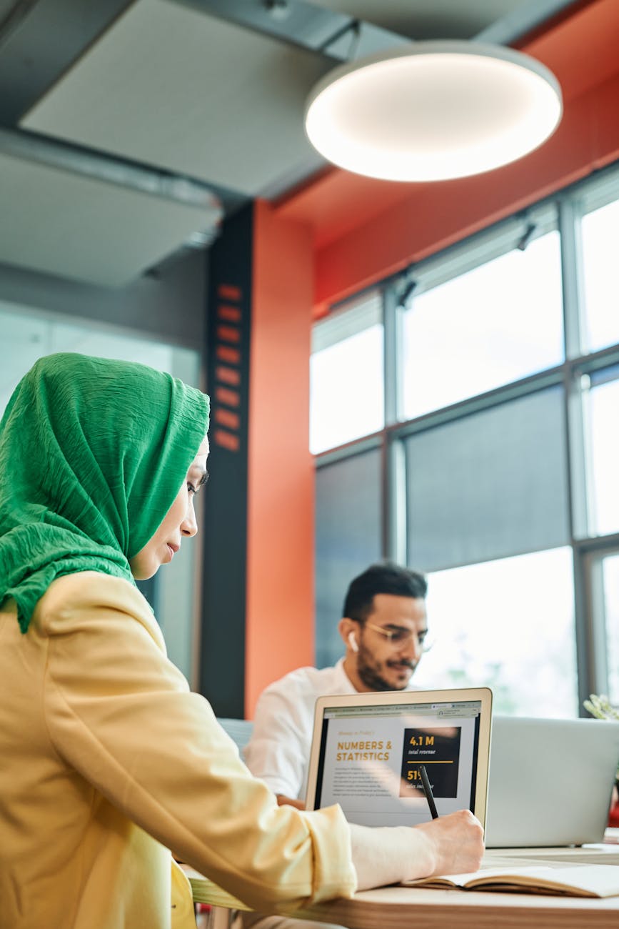 Business professionals working together in a bright, modern office environment.